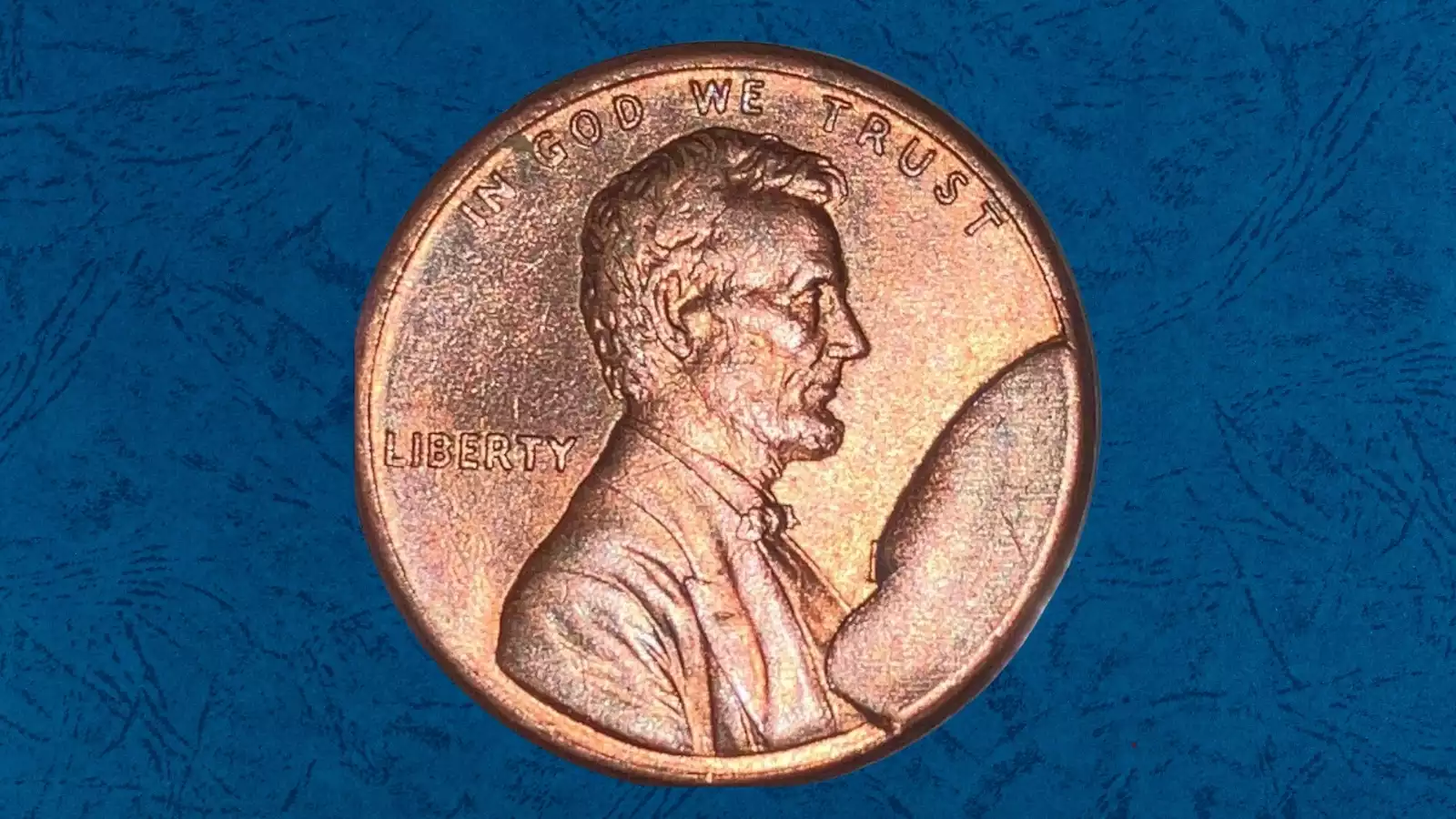 1916 wheat penny die cud error showing raised blob of copper at rim caused by broken die fragment
